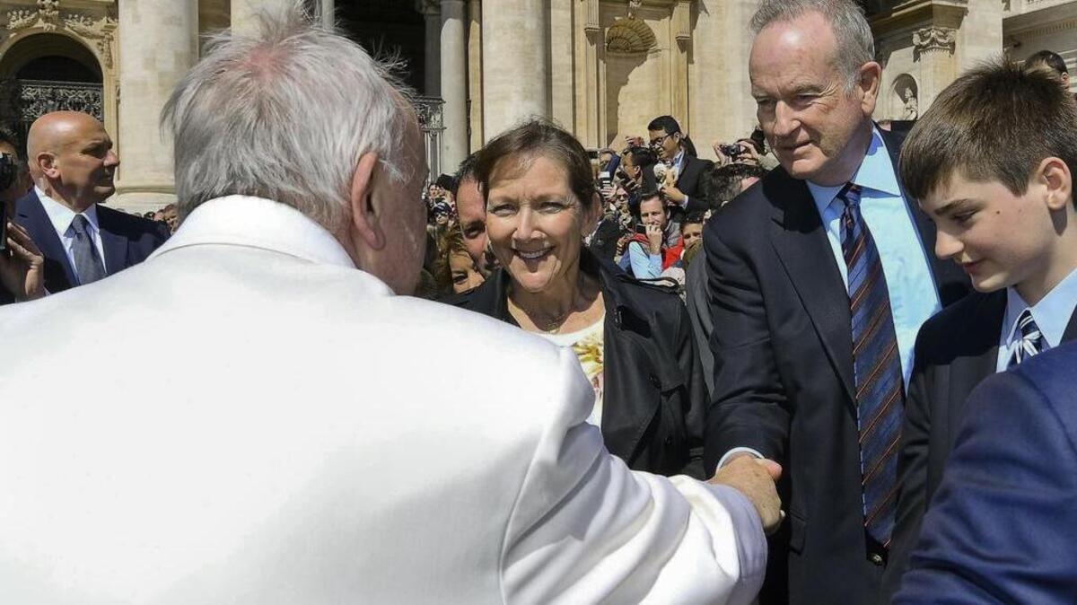 Pope Francis shakes hands with Fox News host Bill O’Reilly, second from right, during his weekly general audience at the Vatican on Wednesday, hours before he was fired.