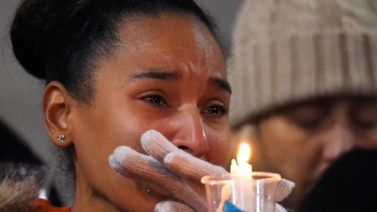 A woman cries in San Bernardino during a vigil Thursday night for shooting victims.