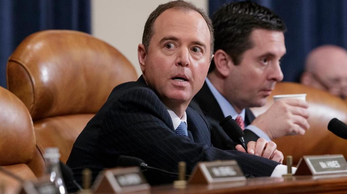 Rep. Adam Schiff, left, and Rep. Devin Nunes listen as FBI Director James Comey testifies before the House Intelligence Committee on Monday.
