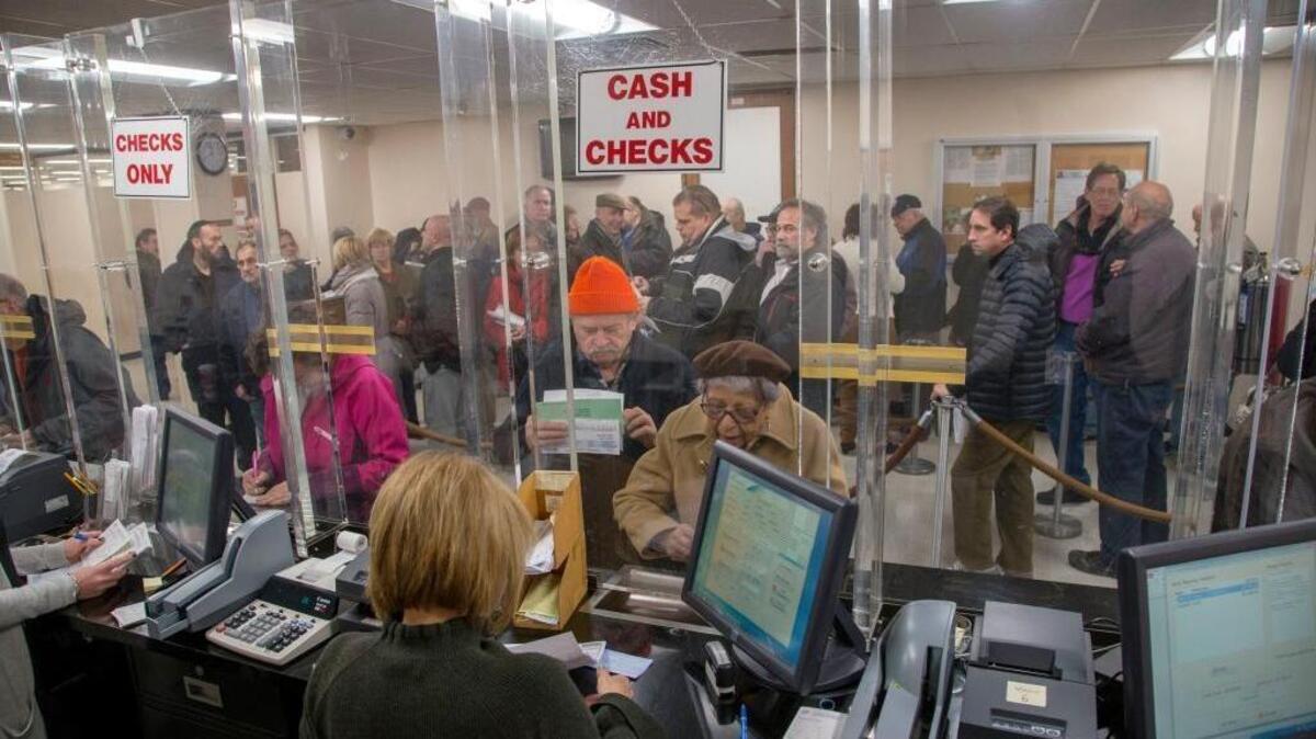 People line up at the tax receiver’s office in Hempstead, N.Y., on Tuesday to pay their real estate taxes before the end of the year.