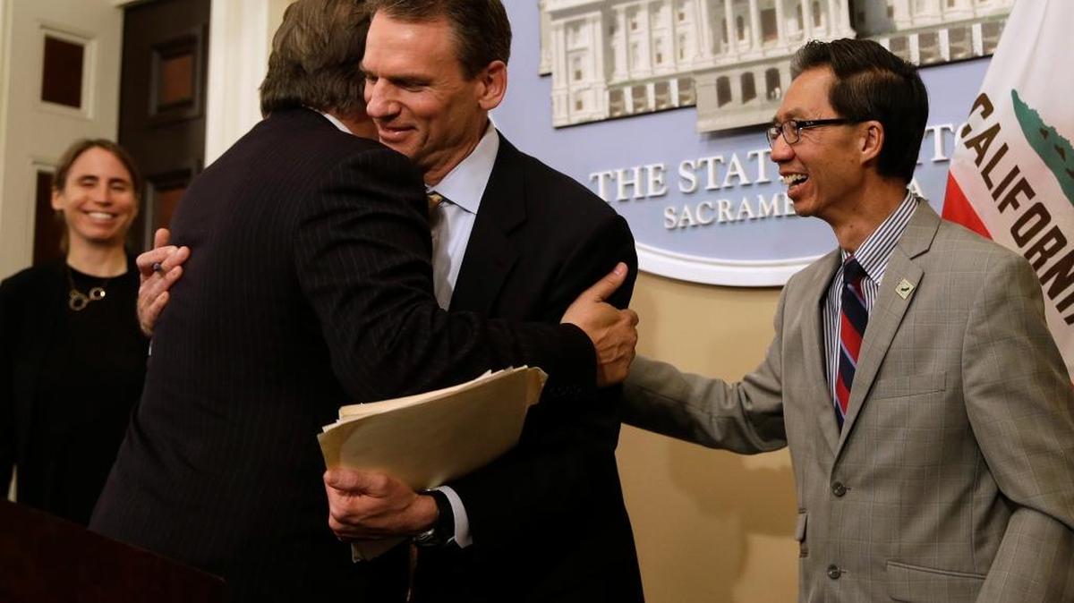 State Sen. Bob Hertzberg, D-Van Nuys, left, and Assemblyman Ed Chau, D-Arcadia, right, celebrate with Alastair Mactaggart, center, after the Legislature approved their data privacy bill on June 28. Mactaggert removed a similar initiative he sponsored from the November 2018 ballot.