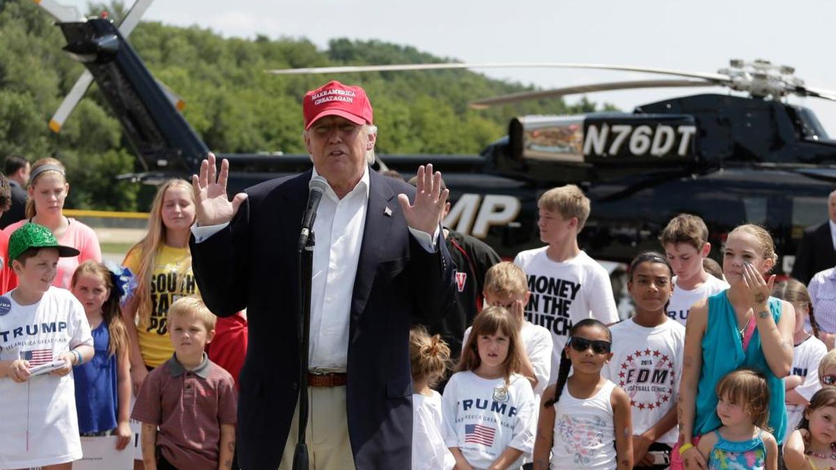 
Donald Trump talks to reporters after arriving by helicopter at the Iowa State Fair on Saturday.
