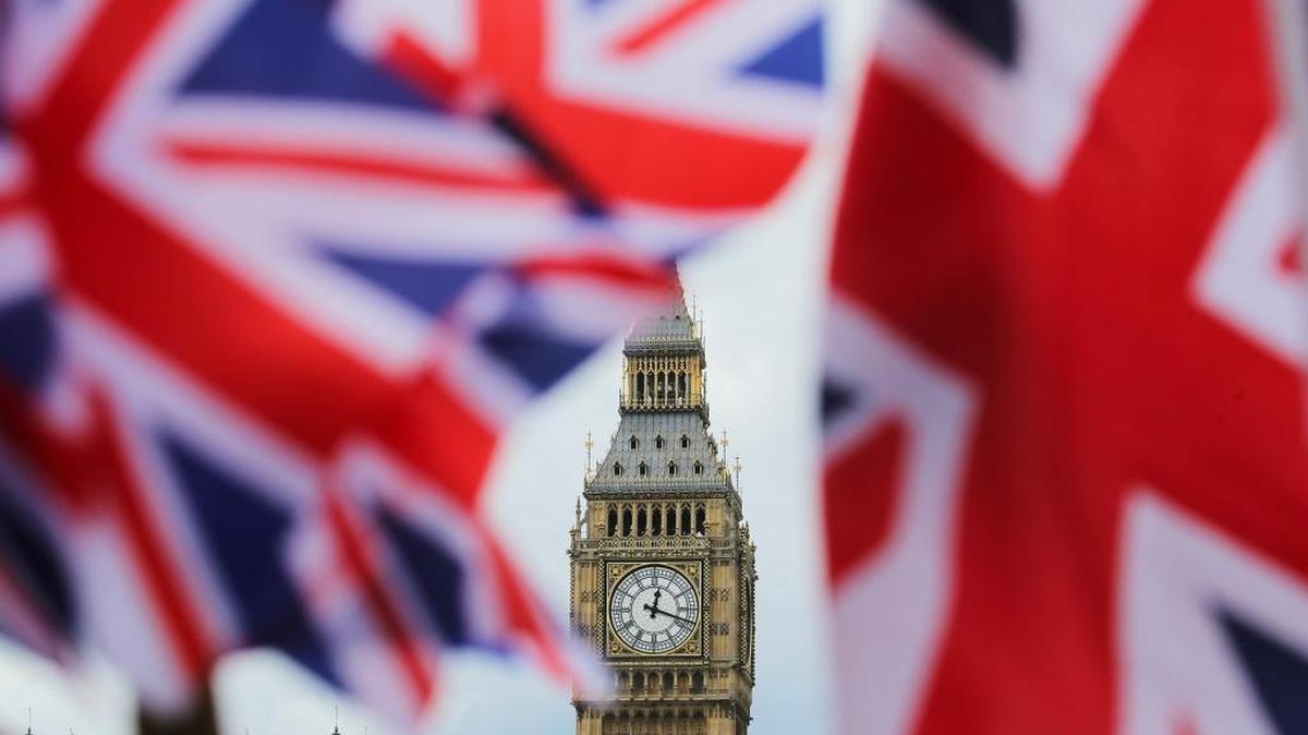 The British national flag flies in front of the Big Ben clock tower on Friday in London. In a referendum the day before, Britons voted by a narrow margin to leave the European Union.