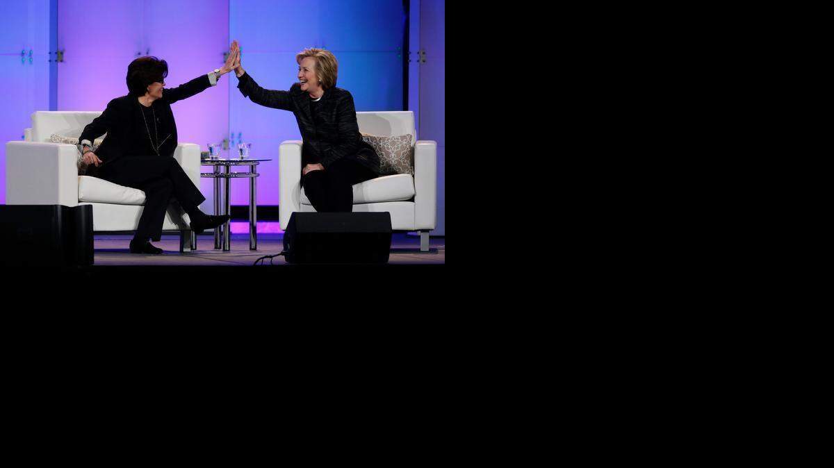 
Hillary Rodham Clinton, right, and technology commentator Kara Swisher high-five during a keynote address at the Watermark Silicon Valley Conference for Women on Tuesday in Santa Clara, where Clinton spoke of the income disparity for women, pointing out that Forbes’ list of the top 100 venture capitalists last year had exactly four females. 

