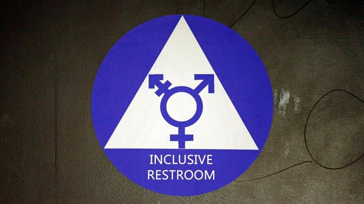 A sticker designates a gender-neutral bathroom at a Seattle high school amid national tension over discrimination against transgender people in schools and locker rooms.