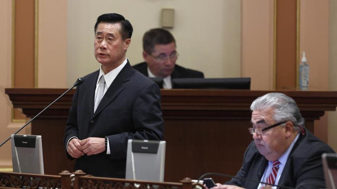 State Sen. Leland Yee, D-San Francisco, left, speaks on a bill, while his seat mate Sen. Ron Calderon, D-Montebello, works at his desk in January 2014. They were suspended with pay after they were charged with corruption.