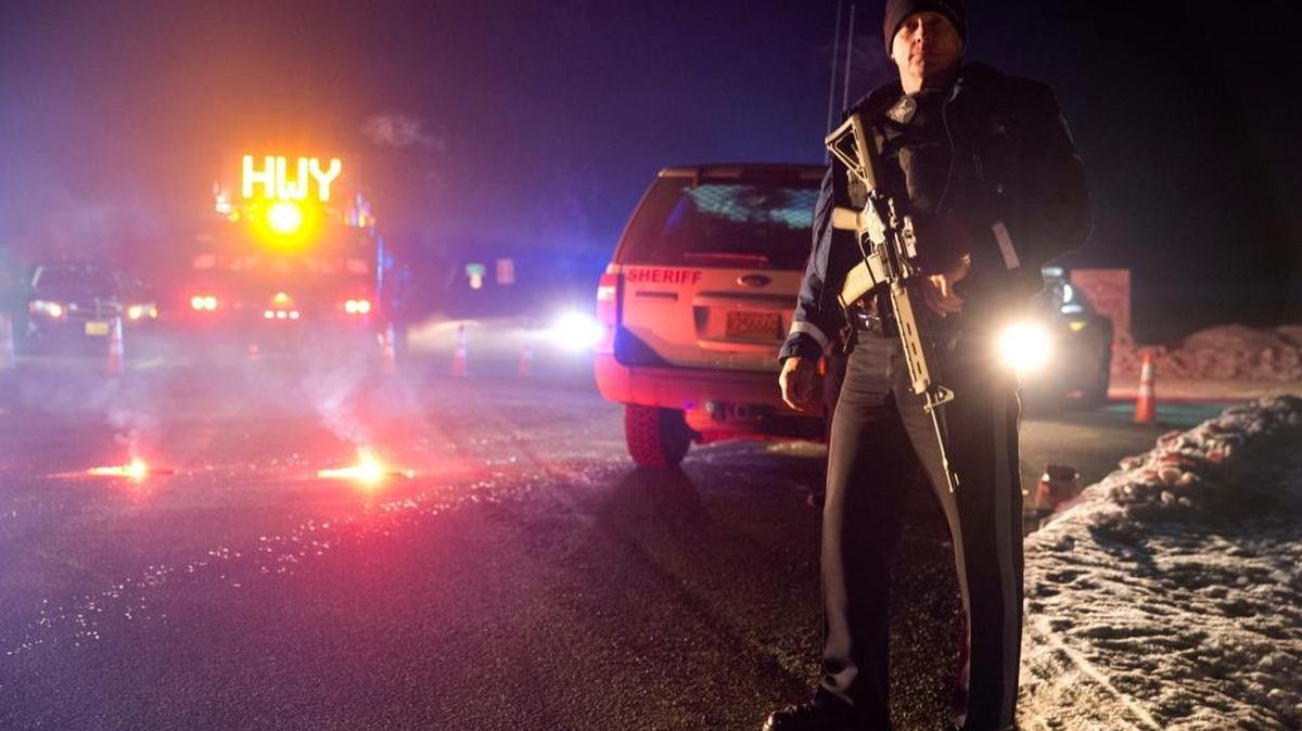 Sgt. Tom Hutchison stands in front of an Oregon State Police roadblock on Tuesday. Shots were fired during the arrest of Ammon Bundy and other militia members who had taken over a national wildlife refuge about a month ago.