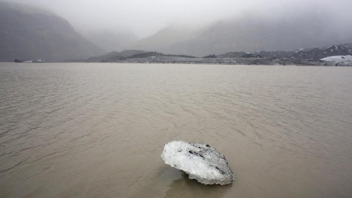 An ice floe floats on a lake in front of the Solheimajokull glacier, where the ice has retreated by 0.6 miles since annual measurements began in 1931.