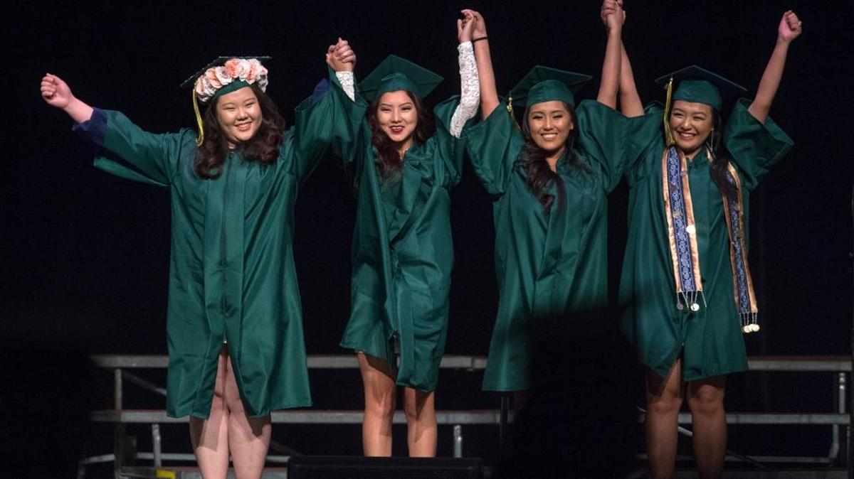 Graduates from John F. Kennedy High School take a bow before getting their diplomas June 15, 2016, at Sacramento Memorial Auditorium. Though they exulted, graduation trends at Sacramento City Unified School District show cause for concern.