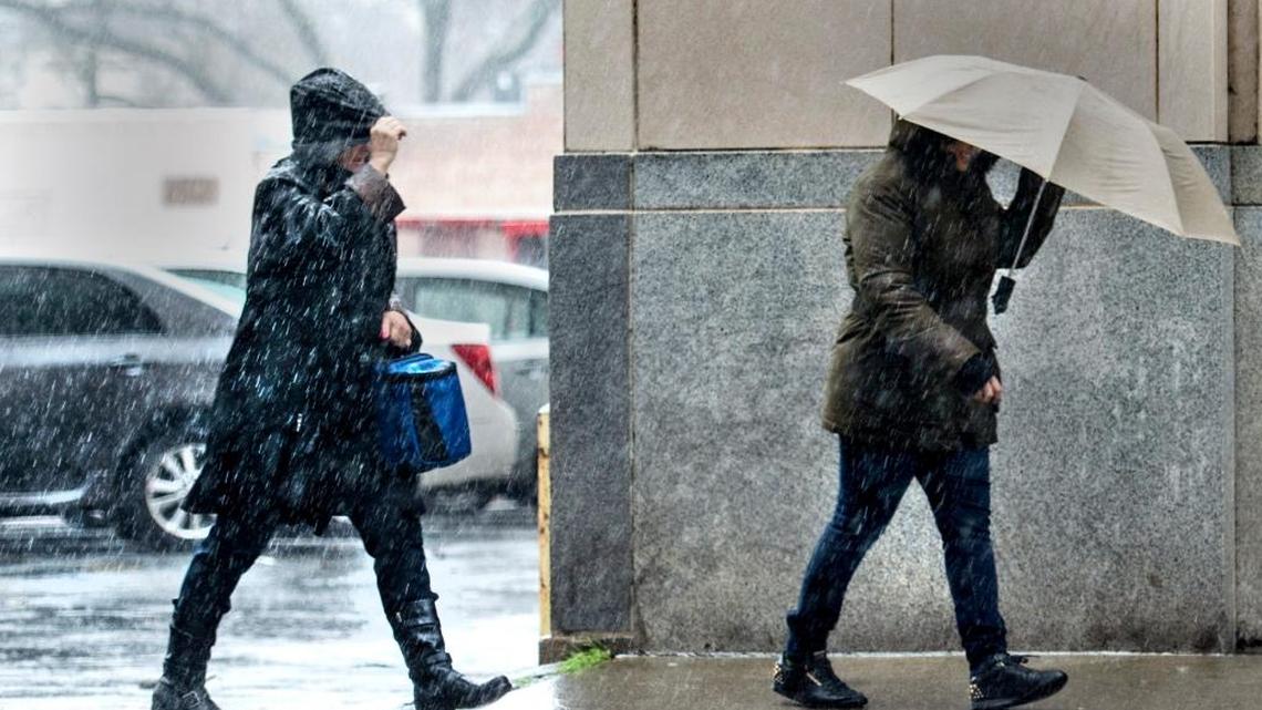 Pedestrians are pelted with rain and wind as they make their way downtown Sunday in Sacramento. The region will continue to need federal help to protect itself from floods.