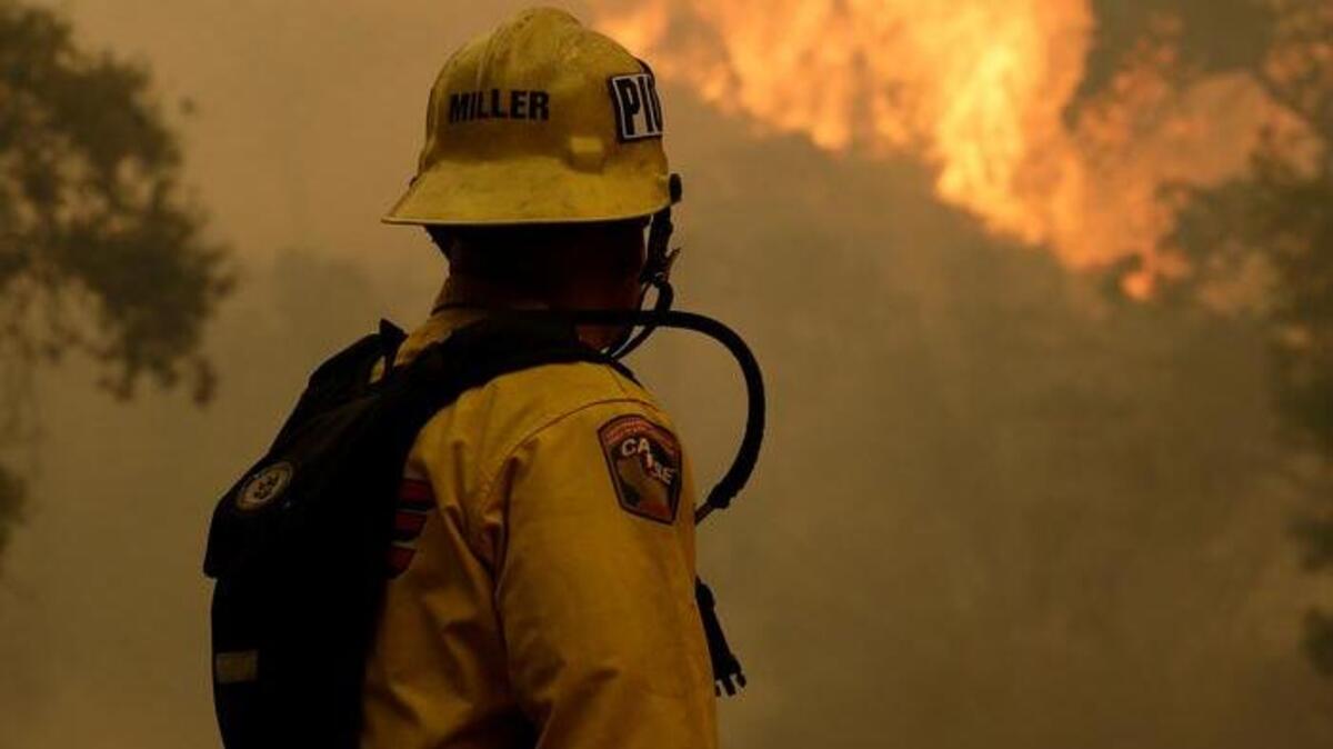 
A Cal Fire engineer works near Lower Lake last week as a wildfire rages, fueled by bone-dry vegetation, triple-digit temperatures and gusting winds. 
