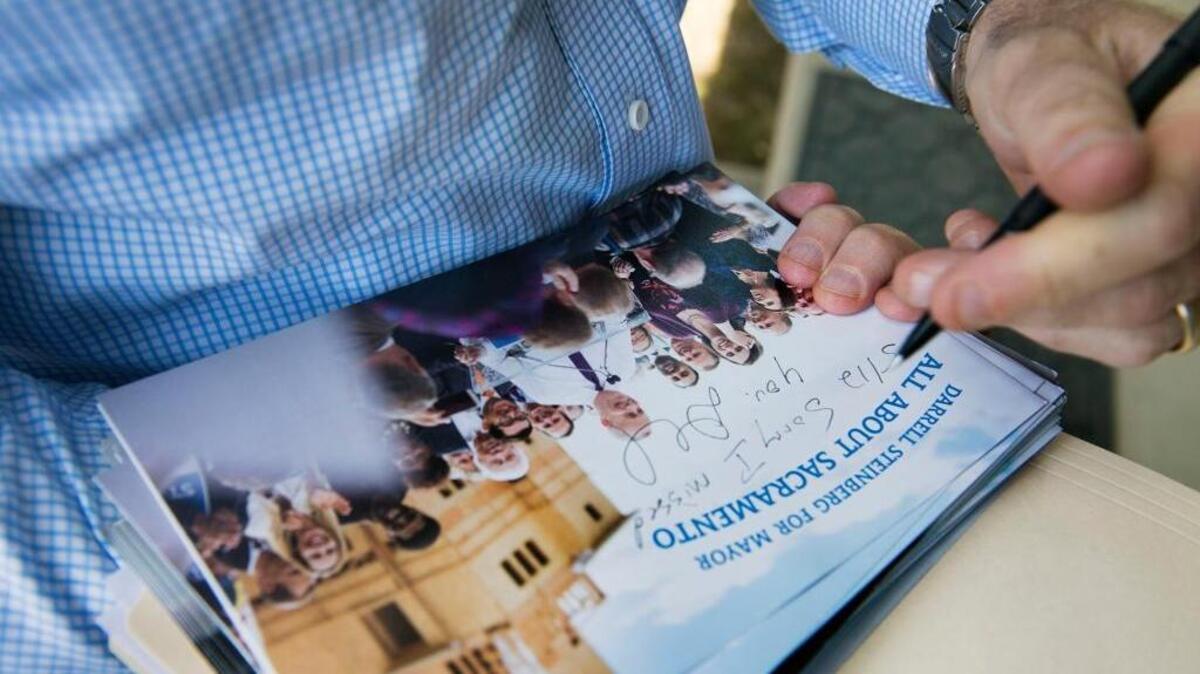 Darrell Steinberg leaves a signed flier as he campaigns in Land Park for Sacramento mayor.