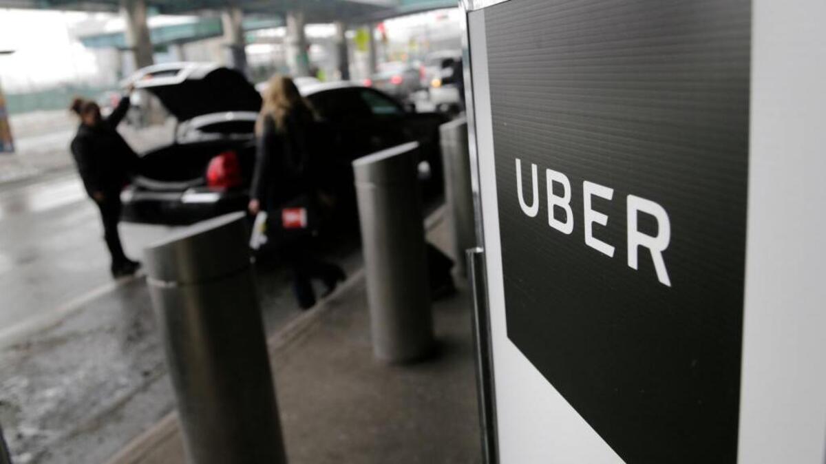 A sign marks a pick-up point for the Uber at LaGuardia Airport in New York.