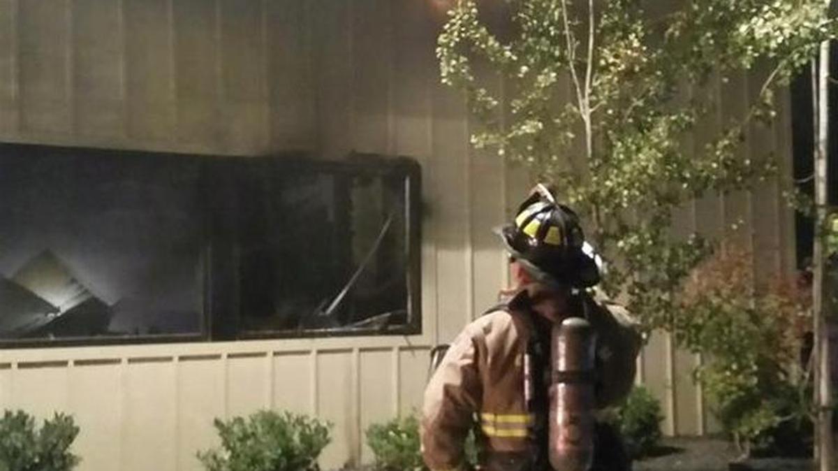 
Firefighters try to put out a fire at a Planned Parenthood clinic in Pullman, Wash., on Friday. The predawn fire heavily damaged the clinic in the college town.
