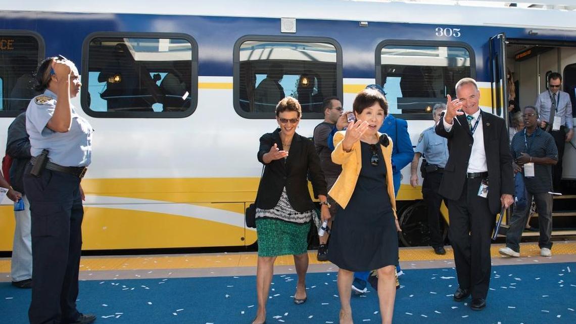 Outgoing Regional Transit General Manager Mike Wiley, right, and Congresswoman Doris Matsui, center, are greeted by confetti and a marching band as new Blue Line train arrives at Cosumnes River College last August.