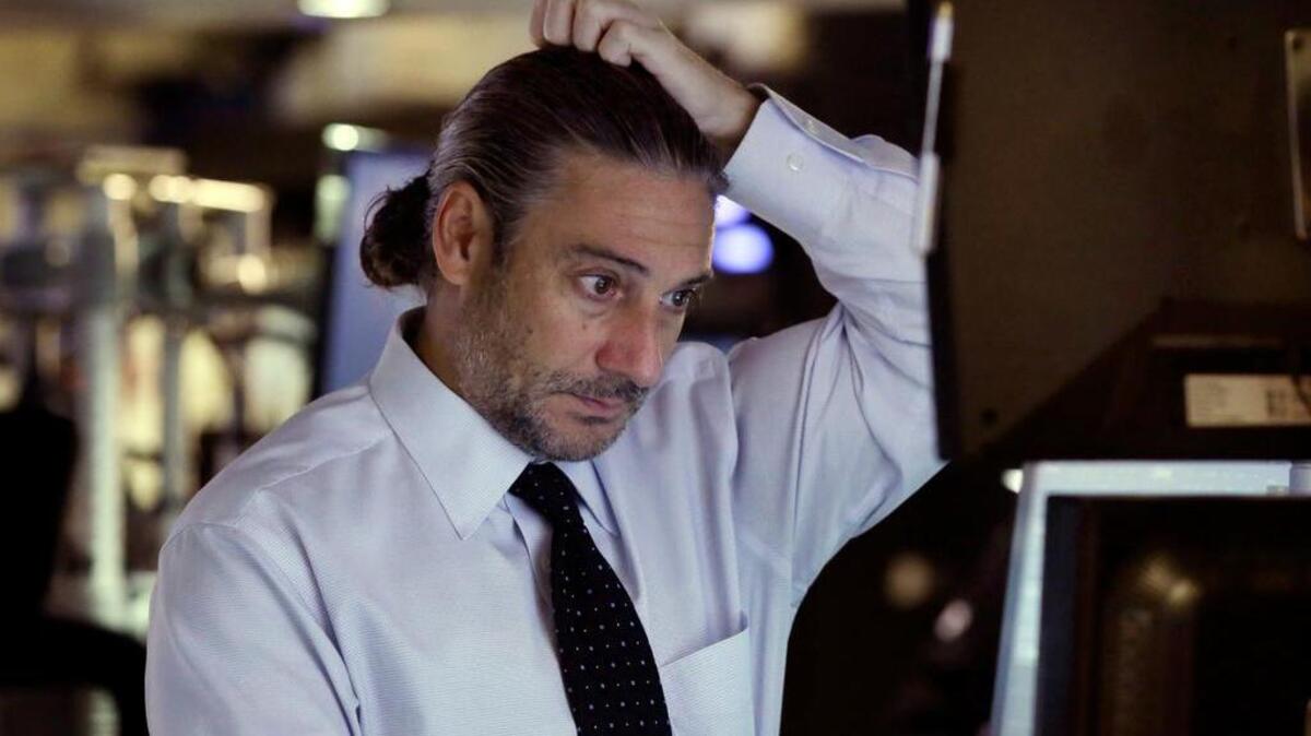 
A trader checks screens on the floor of the New York Stock Exchange on Wednesday, when indexes rebounded after slumping for six straight days. 

