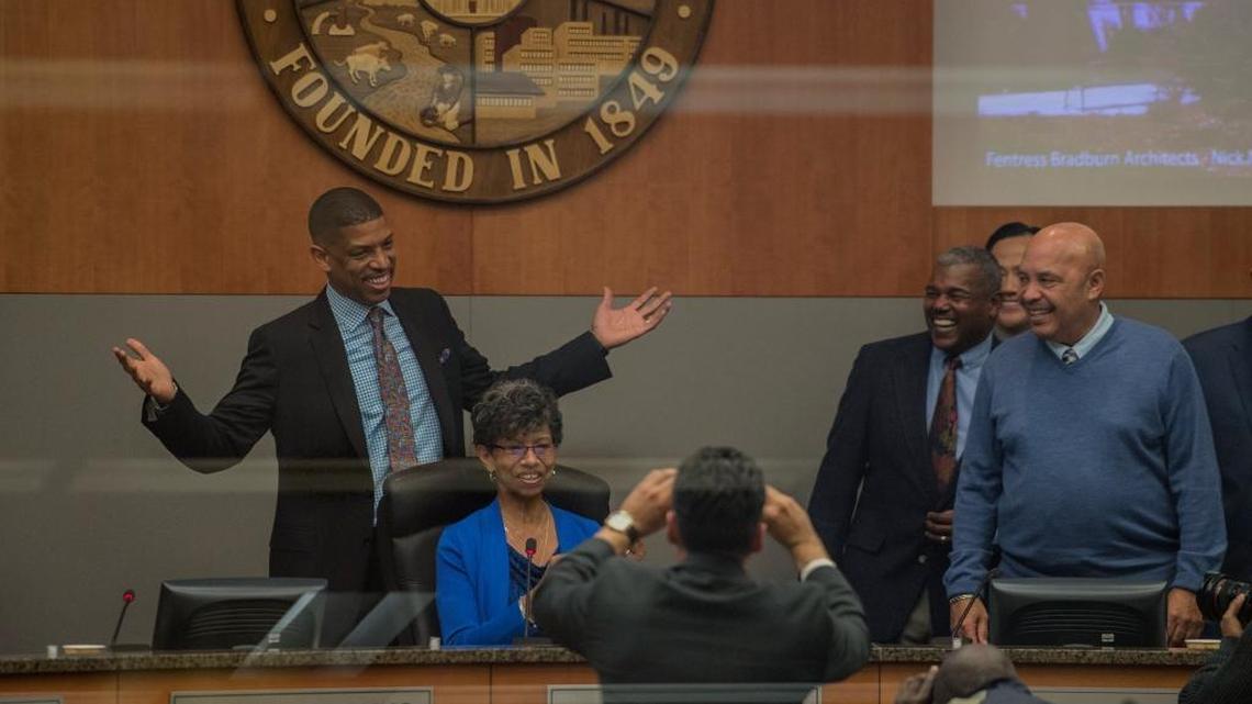 Sacramento Mayor Kevin Johnson stands over his mother, Georgia West, after a ceremony Tuesday to honor his eight years in office.