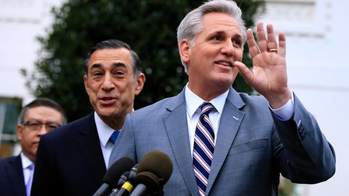 House Majority Leader Kevin McCarthy and Rep. Darrell Issa respond to questions about California wildfires outside the White House on Dec. 12. McCarthy is rounding up votes for the Republican tax bill; Issa voted against an earlier version.