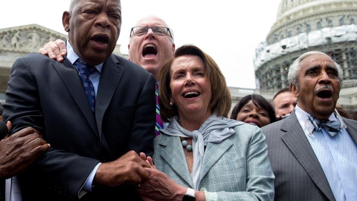 From left, Democratic Reps. John Lewis, Joseph Crowley, Nancy Pelosi and Charles Rangel sing “We Shall Overcome” on Capitol Hill in Washington.