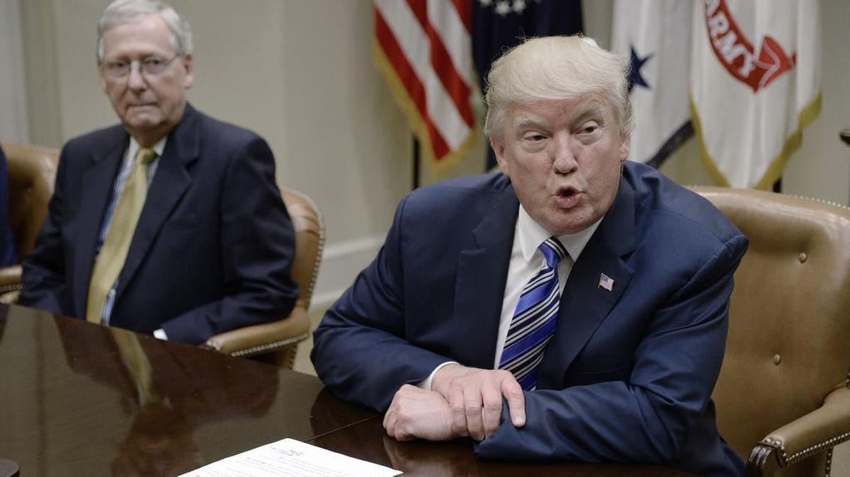 President Donald Trump speaks as Senate Majority Leader Mitch McConnell, left, looks on during a meeting with House and Senate leadership on June 6, 2017, in the Roosevelt Room of the White House.