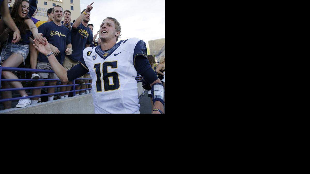
California quarterback Jared Goff, 16, right, celebrates with fans after California defeated Northwestern 31-24 in an NCAA college football game in August. 
