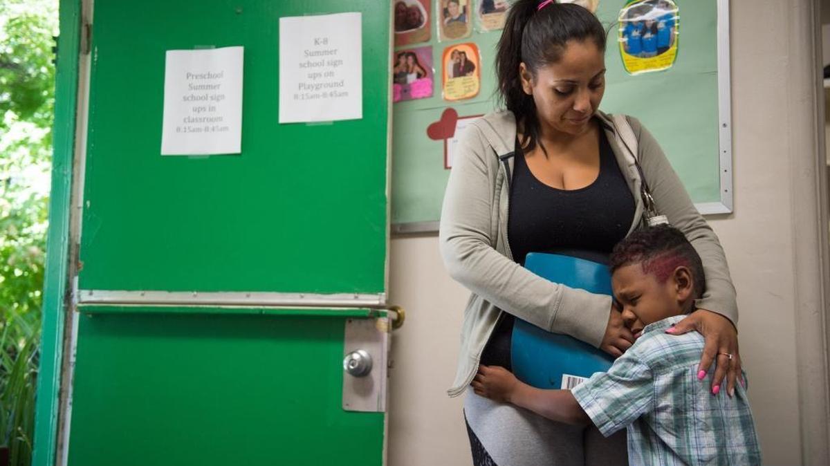 Davida Gomez hugs her son, William Swilley, 5, before class at the Mustard Seed School. Gomez, who has three children, was homeless in July.