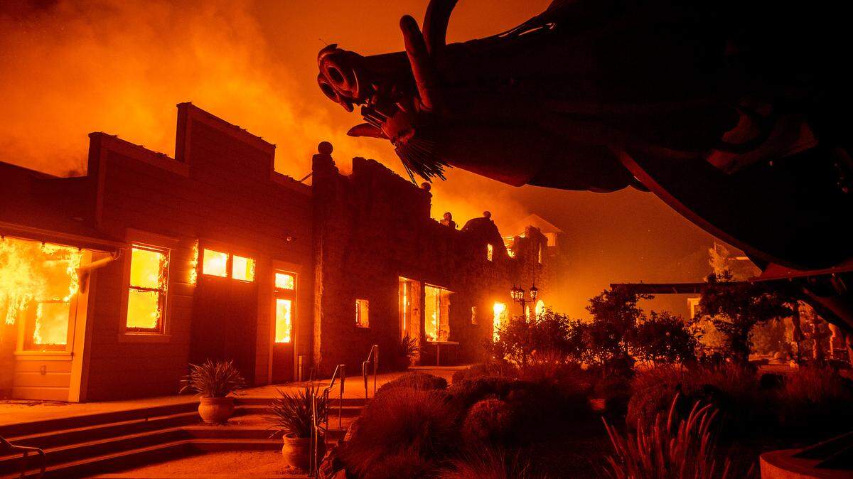 FILE - Flames from the Kincade Fire consume Soda Rock Winery on Oct 27, 2019, in Healdsburg, Calif.