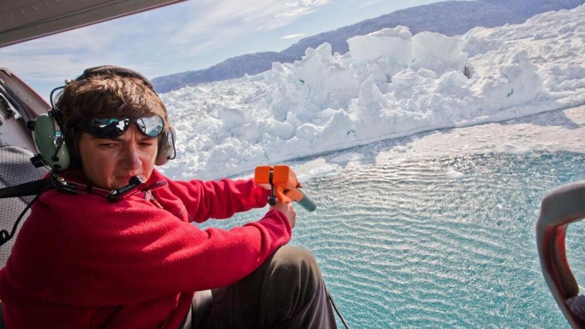 From a helicopter hovering over Greenland, oceanographer Fiammetta Straneo takes measurements to determine how fast the water is melting the nearby Helheim Glacier.