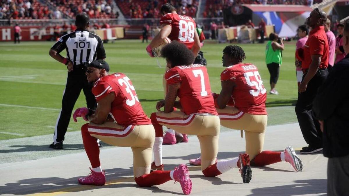 San Francisco 49ers safety Eric Reid (35), quarterback Colin Kaepernick (7) and linebacker Eli Harold (58) kneel during the national anthem before their game against the Tampa Bay Buccaneers in Santa Clara last Sunday.