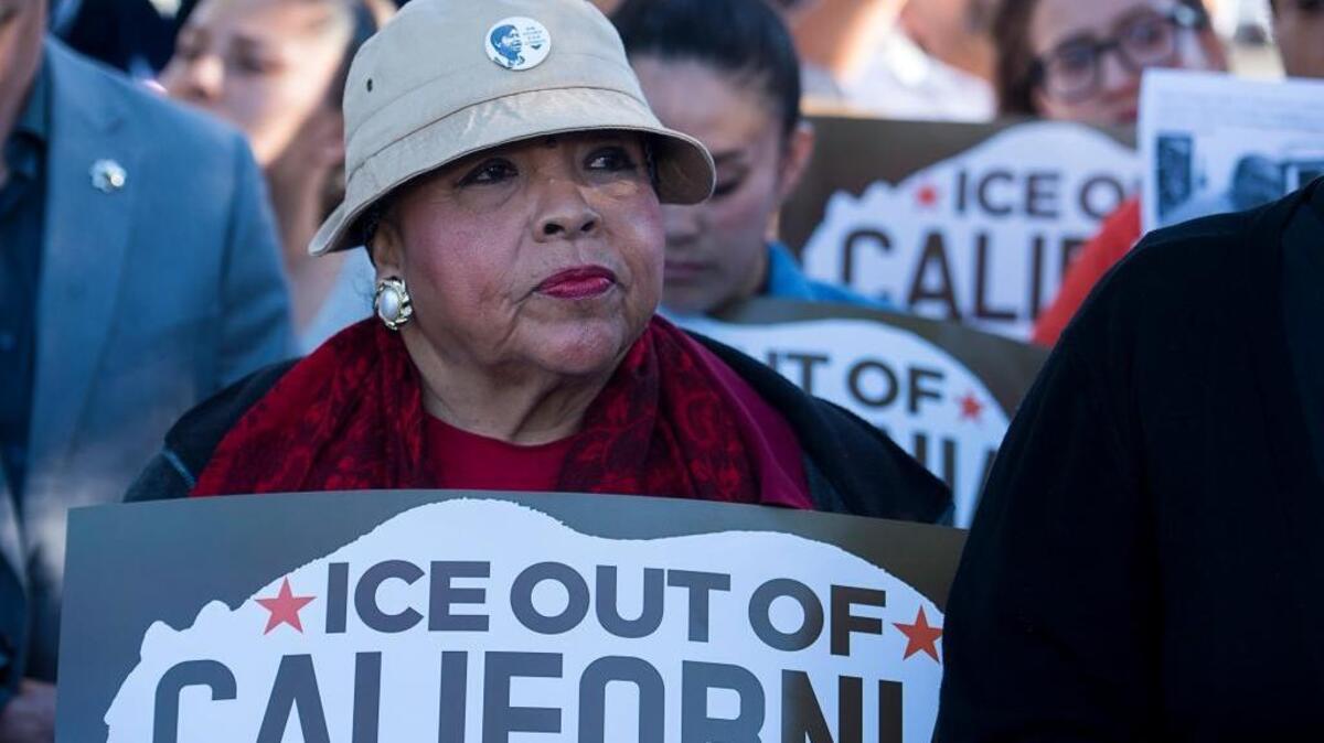 Juanita Ontiveros of the Sacramento Area Congregations Together listen to speakers Mayor Darrell Steinberg and Senator Kevin de Leon outside a community immigration forum held by acting Immigration and Customs Enforcement head Thomas Homan and Sheriff Scott Jones at the Sacramento County Youth Gym on Tuesday. Many people were turned away after the auditorium was filed to capacity.