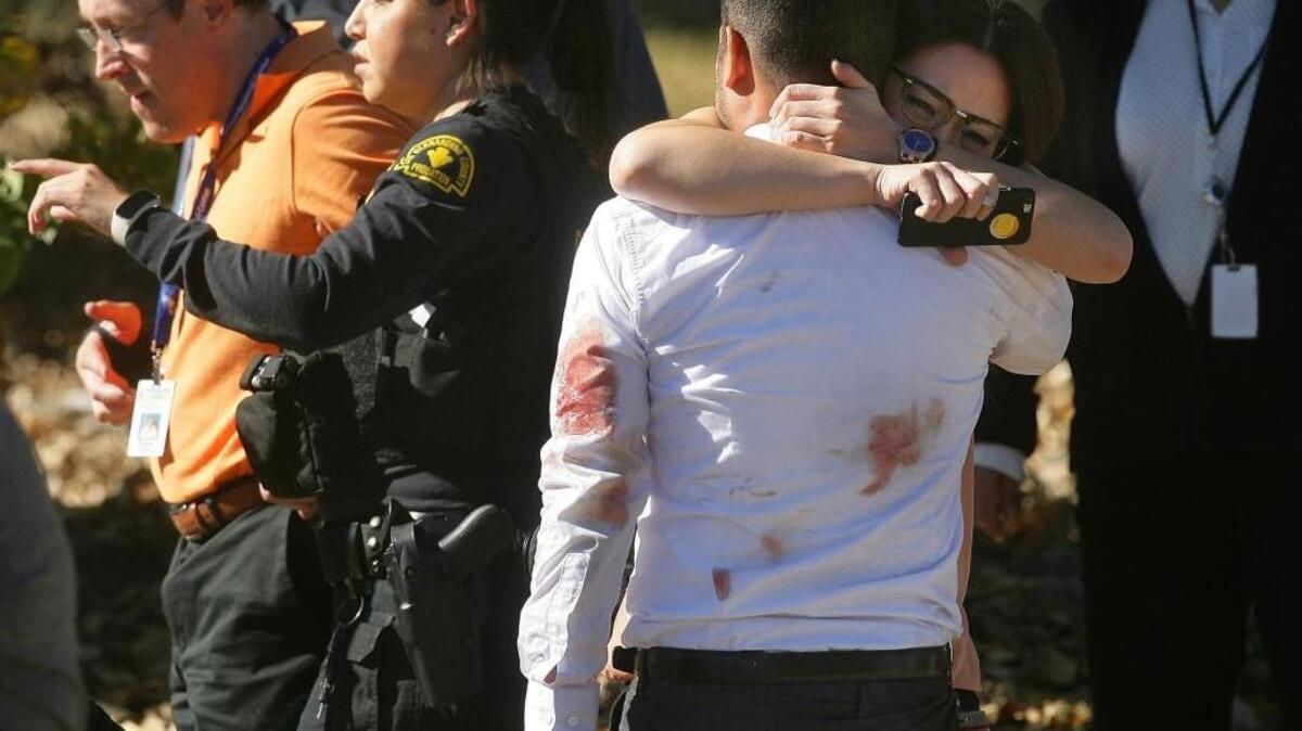 A couple embraces following a shooting that killed 14 people Wednesday at a social services facility in San Bernardino.