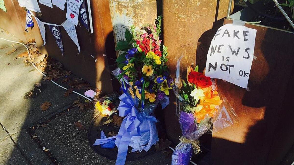 Flowers and notes left by well-wishers are displayed outside Comet Ping Pong, a pizza restaurant in Washington, D.C., that has been the target of fake news stories linking it to a child sex trafficking ring.
