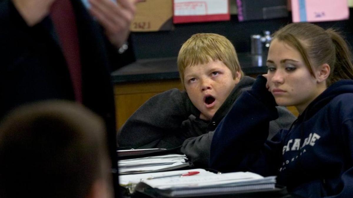 Zack Shellenberger, 14, center, and Nicole Greer, 13, right, try to keep their attention focused on Dr. Richard Stack, from Mercy Sleep Center, at Will Rogers Middle School in 2006.