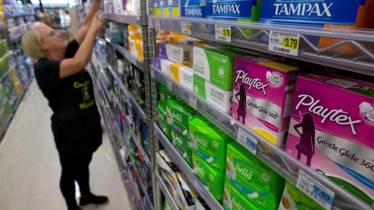Tammy Compton restocks tampons at Compton’s Market in Sacramento. Gov. Jerry Brown vetoed a bill that would’ve waived taxes on tampons and other feminine hygiene products.