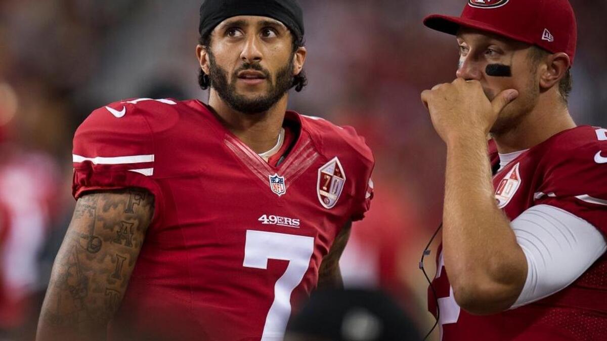 San Francisco 49ers quarterback Colin Kaepernick, left, says he will continue to sit during the national anthem to bring attention to police brutality and injustices of people being oppressed.