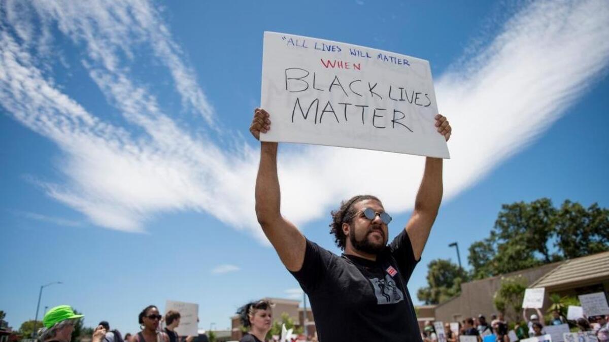 Keyan Bliss holds up a sign in the middle of Fair Oaks Boulevard during a Black Lives Matter demonstration. Vigilant community groups, such as Black Lives Matter, can make a positive difference by keeping us awake to the challenges of stigma and race. one letter writer asserts.