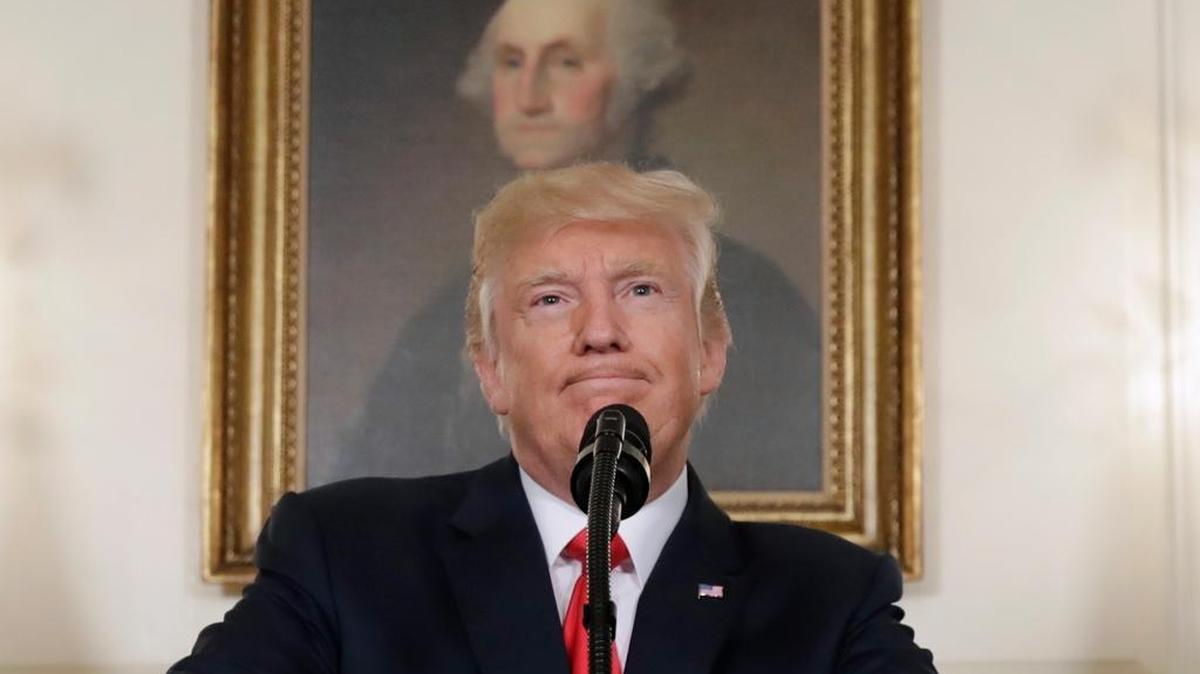 In this Aug. 14, 2017, photo, President Donald Trump pauses while speaking in the Diplomatic Reception Room of the White House in Washington. Is it really so far-fetched to put Robert E. Lee in the same category as George Washington, as President Donald Trump suggested Tuesday? Many historians say yes.