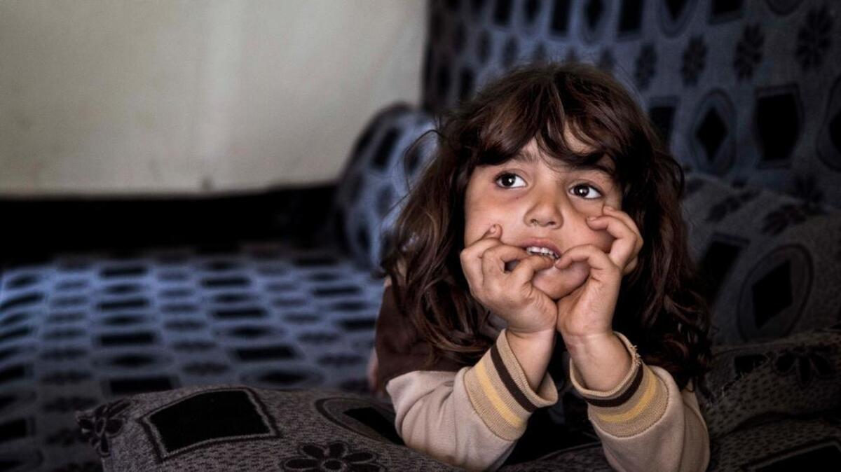 Syrian refugee Simav Nuh rests inside an informal tent settlement in Irbil, Iraq. Approximately 240,000 refugees who fled the fighting in Syria live in Iraq. Their children are neither citizens of Syria, their families’ country of origin, or of Iraq, the country where they now live.