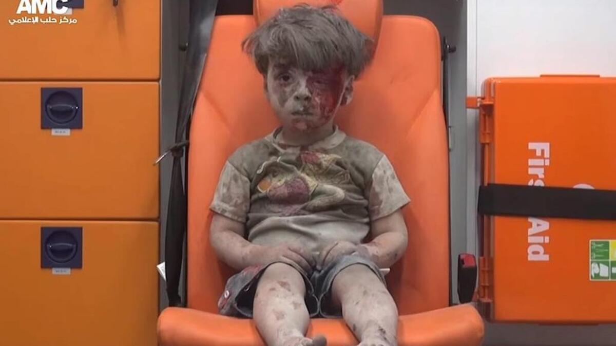 Omran Daqneesh, 5, sits in an ambulance after a house was destroyed in an airstrike on in Aleppo, Syria. Eight people, including five children, are said to have been killed in the attack.
