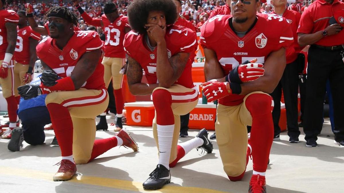 From left, Eli Harold, Colin Kaepernick and Eric Reid kneel during the national anthem before their NFL game against the Dallas Cowboys last October. Kaepernick hasn’t joined a team since leaving the San Francisco 49ers as a free agent.