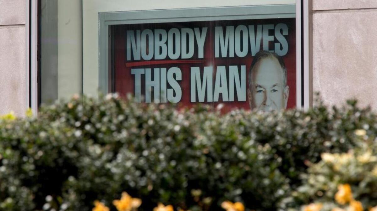 A poster featuring Bill O’Reilly is displayed at the News Corp. headquarters building in Manhattan on April 19. He was fired from Fox News Channel following reports that five women had been paid millions of dollars to keep quiet about harassment allegations.