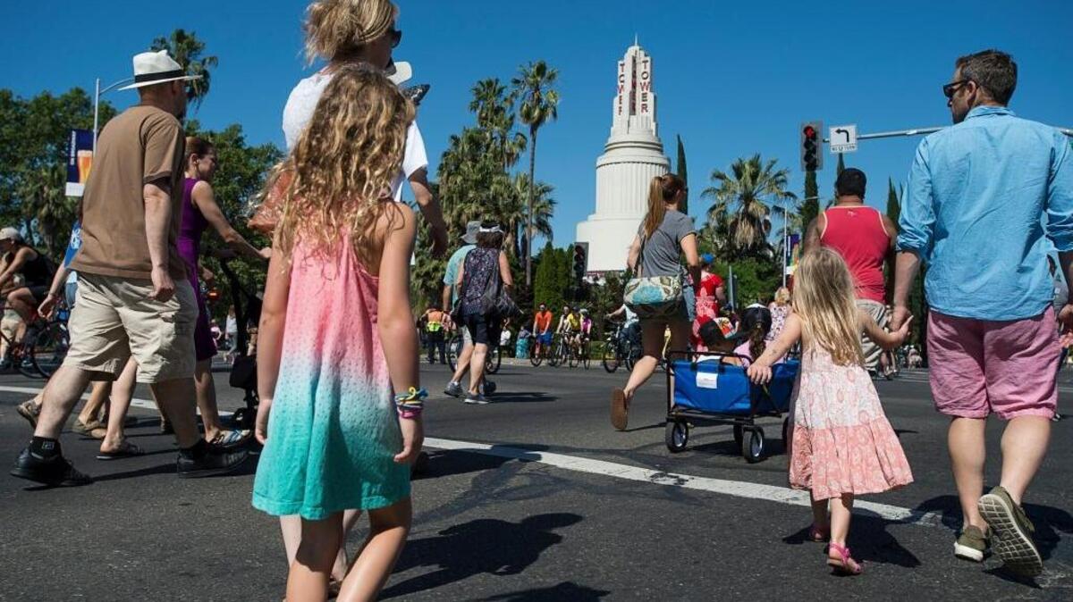People take a stroll down Broadway, which was temporarily closed last Sunday for Sacramento’s first “open street” event.
