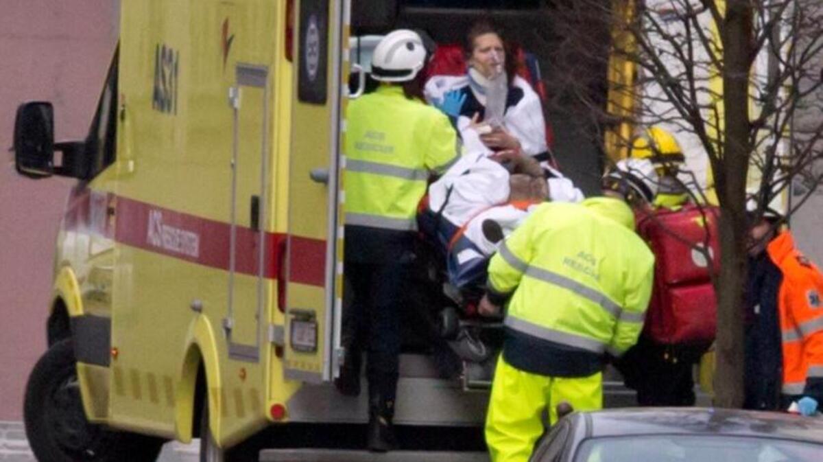A woman is evacuated in an ambulance by emergency services after an explosion in a metro station in Brussels.