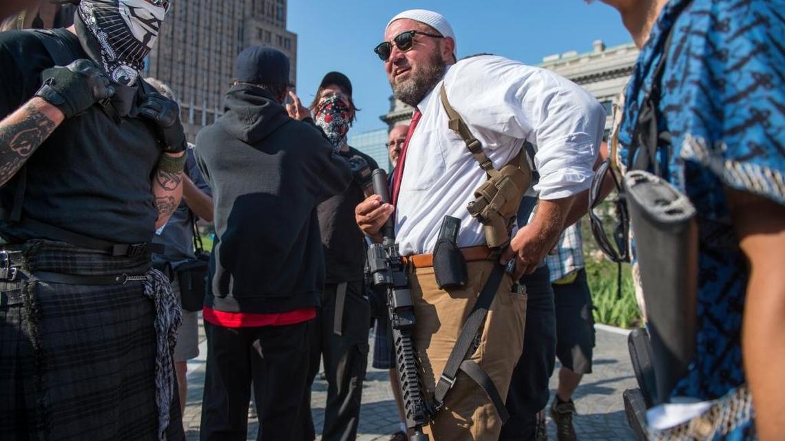 Micah Naziri and others carry assault weapons in downtown Cleveland during the Republican National Convention as part of a “militant anti-fascist statement against the policies that Trump has proposed.”