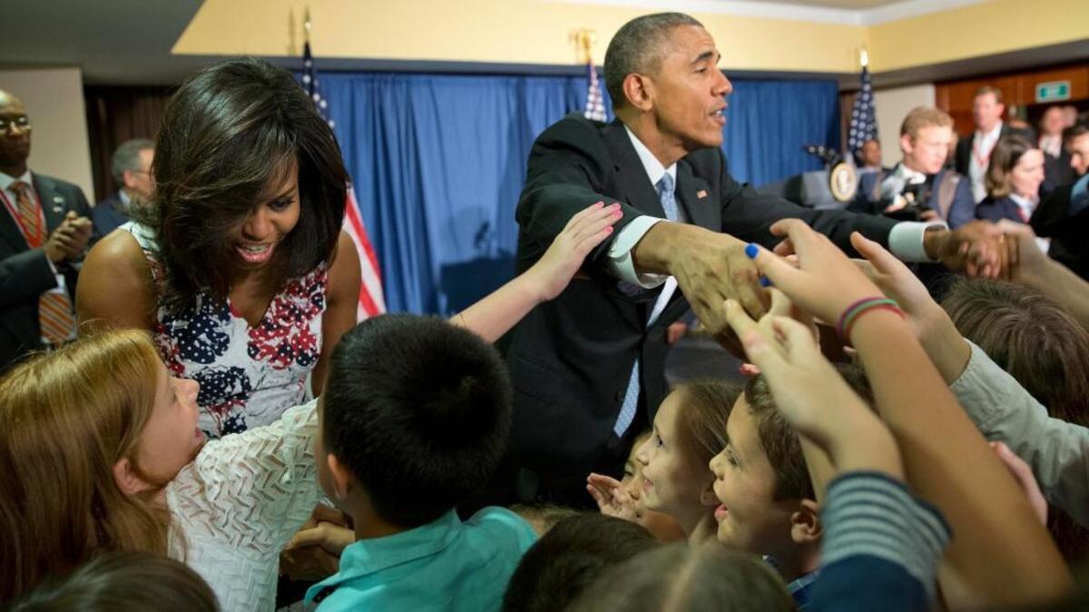 President Barack Obama and first lady Michelle Obama greet children and families of U.S. Embassy personnel at the Melia Habana Hotel in Havana, Cuba, on Sunday.