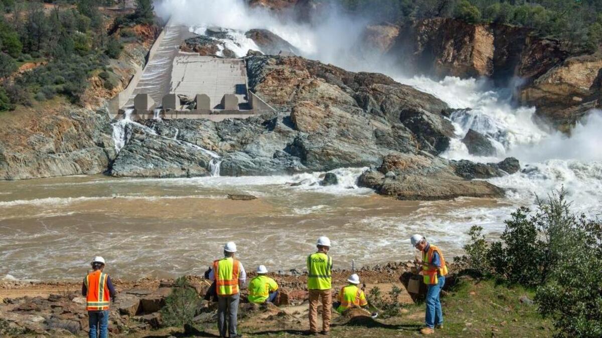 Department of Water Resources workers check on the flow of the Oroville Dam's main spillway last month.
