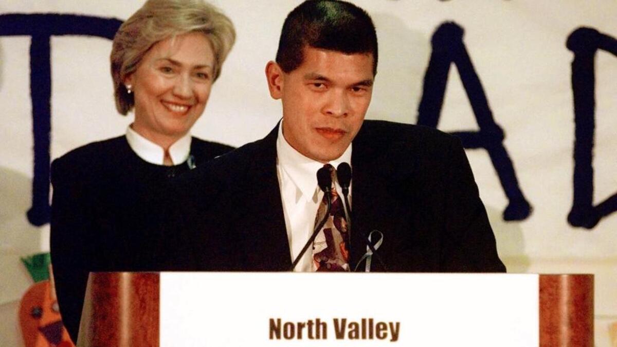 Then-first lady Hillary Clinton waits as Ismael Ileto introduces her during an address at the North Valley Jewish Community Center in November 1999.