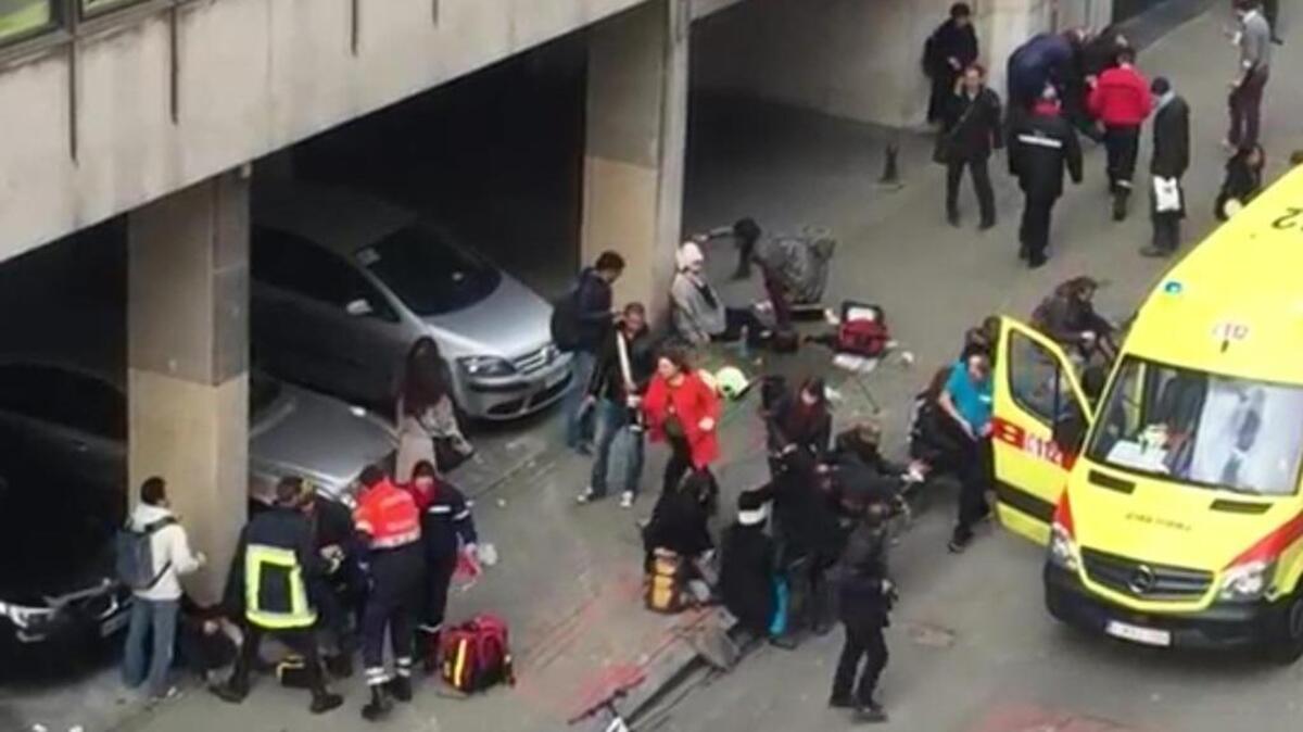 People receive treatment near Maelbeek metro station in Brussels after bombs exploded Tuesday. The Brussels airport also was attacked.