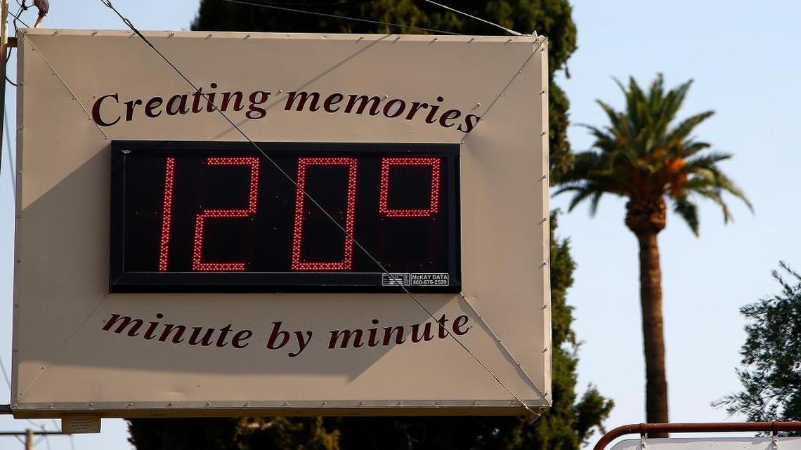 A local temperature sign reads 120-degrees as temperatures climb to near-record highs Tuesday in Phoenix. The National Weather Service forecasts a high of 120 degrees, which is has only hit three times in recorded history in Phoenix, the last time 22 years ago.