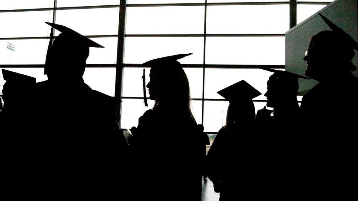 Eastern Michigan University graduates socialize before their commencement at the Convocation Center in Ypsilanti, Mich.